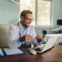A Medical Representative Watching on His Laptop