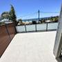 Tiled first floor deck with glass handrail and screens