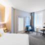 Elegant hotel room featuring a cozy bed