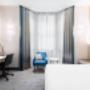 Bright hotel room with cozy bed