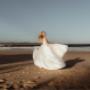 Bride walking through a breathtaking natural landscape, creating a cinematic and timeless wedding portrait.