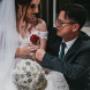 Bride and groom sharing a heartfelt moment during their wedding ceremony, captured with soft light and genuine emotion.