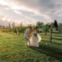Bride and groom embracing in golden hour light, capturing a cinematic outdoor wedding moment.