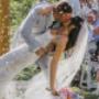 Romantic newlywed couple sharing an intimate moment beneath the veil, creating a soft and emotional wedding portrait.