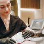 Practitioner performing HIFU treatment using handheld device