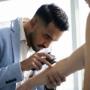 Dr Roshan Dalpadado conducting a mole check